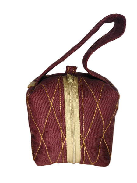Front view of burgundy Boxed Mini-me Makeup Bag with gold diamond stitching, cream zip and matching loop handle. 